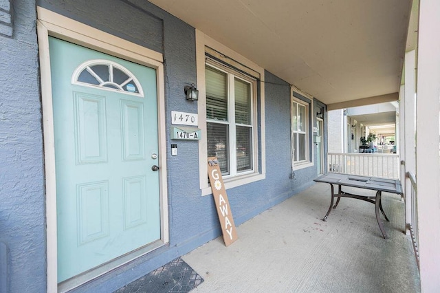 view of exterior entry featuring a porch