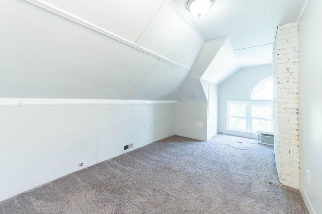 additional living space featuring carpet flooring and lofted ceiling