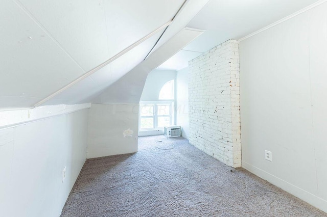 bonus room with carpet, vaulted ceiling, and a wall unit AC