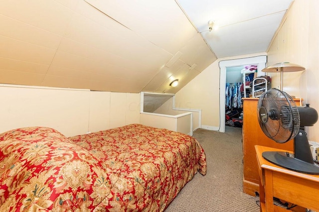 carpeted bedroom featuring vaulted ceiling and a closet