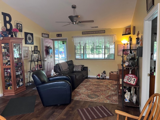 living room with hardwood / wood-style flooring, ceiling fan, and vaulted ceiling