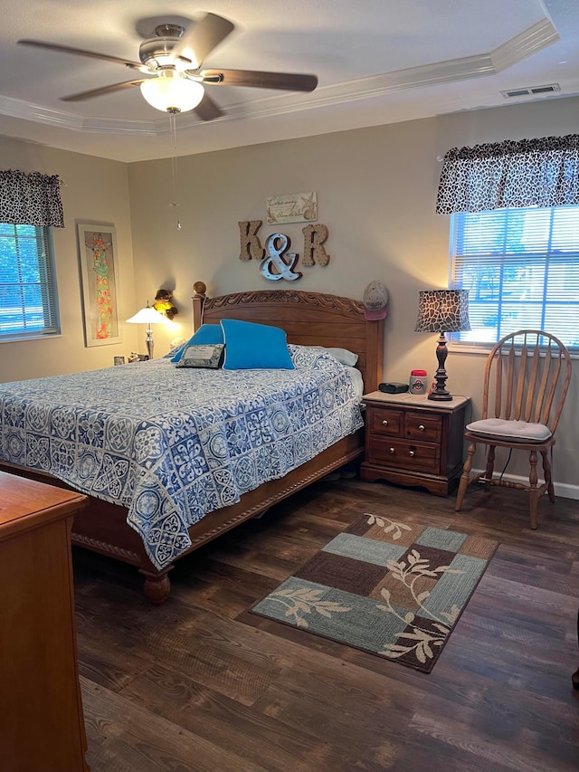 bedroom featuring ceiling fan, ornamental molding, and dark wood-type flooring