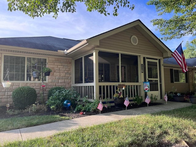 view of front of property featuring a sunroom