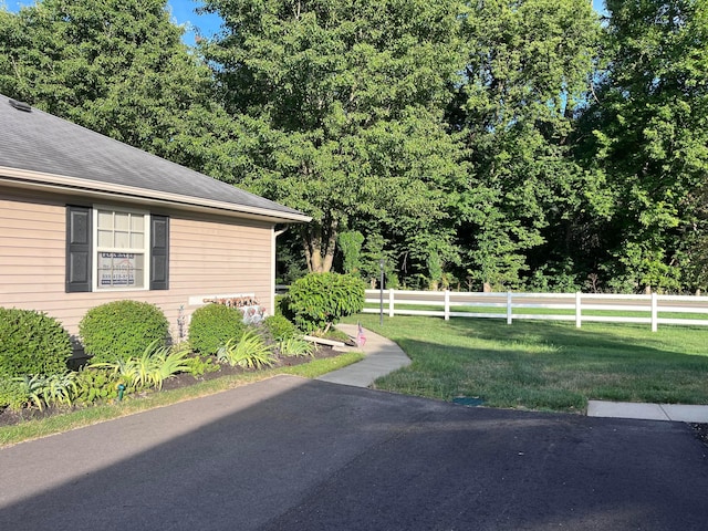 view of property exterior with a yard