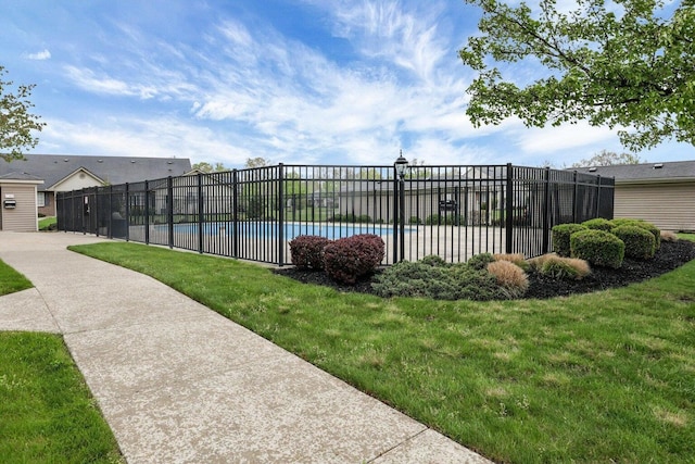 view of pool with a yard