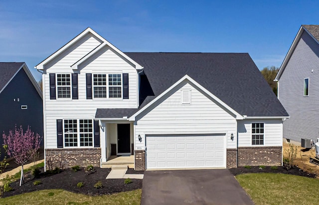 9931 Glenfield Ct Lot 37, Plain City, OH 43064 - traditional-style house featuring driveway, central AC unit, an attached garage, and brick siding