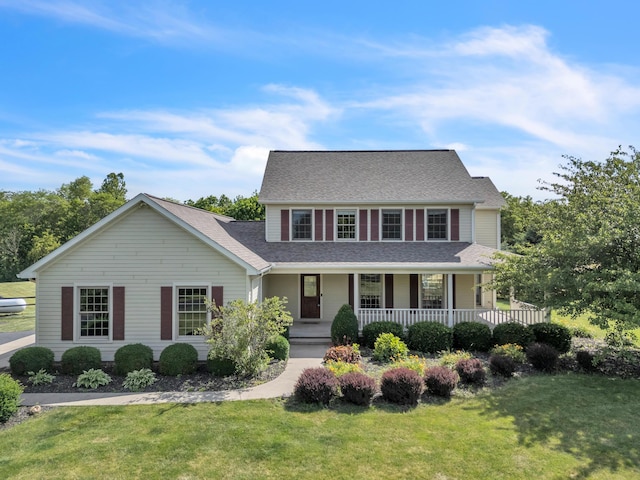 view of front of house with covered porch and a front yard