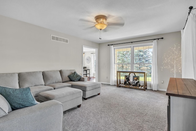 carpeted living room with ceiling fan