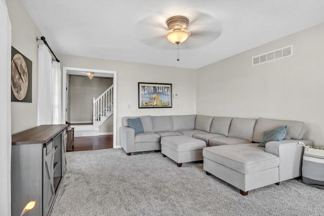 living room with ceiling fan and carpet