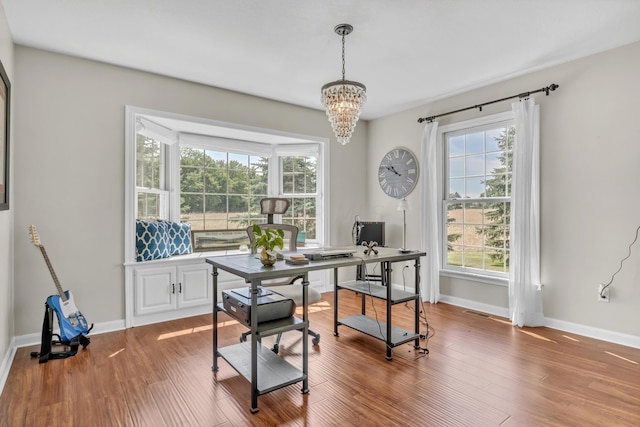 dining room with hardwood / wood-style floors and a chandelier