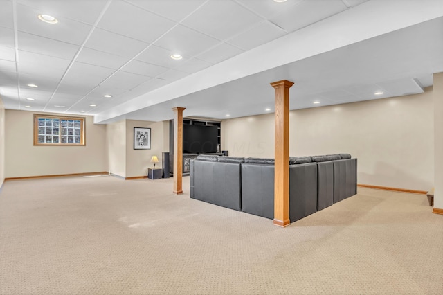 unfurnished living room featuring carpet and a paneled ceiling