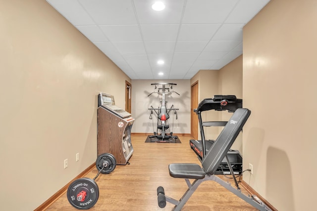 exercise area featuring hardwood / wood-style flooring and a drop ceiling