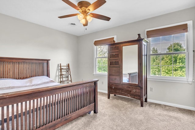 bedroom with ceiling fan and light colored carpet