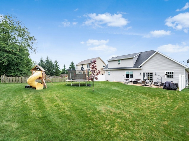 view of yard with a playground, a patio area, and a trampoline