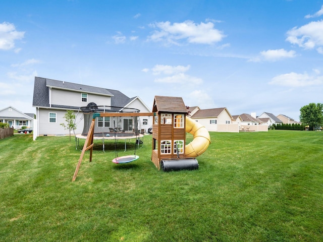 view of play area with a lawn and a trampoline