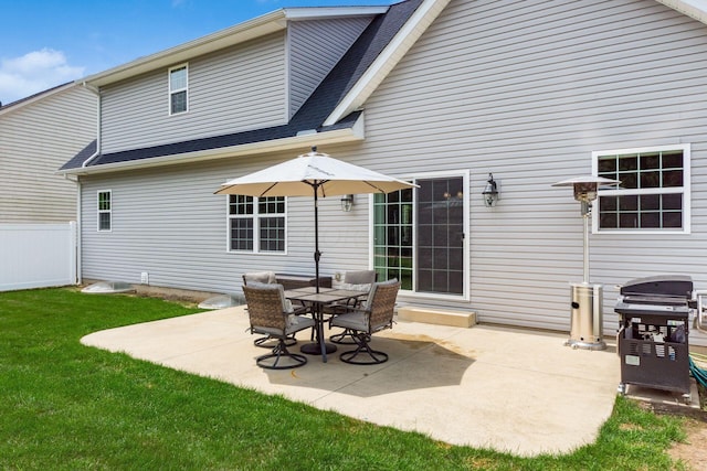 back of property featuring a yard and a patio area