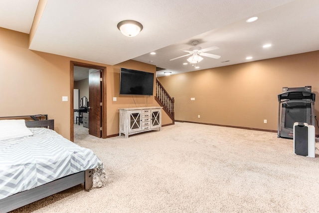 bedroom with ceiling fan and light carpet