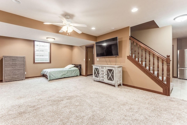 carpeted bedroom with stainless steel fridge and ceiling fan