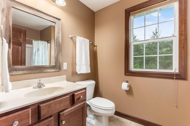 bathroom with toilet, vanity, tile patterned floors, and walk in shower