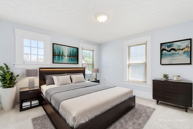 carpeted bedroom featuring a textured ceiling