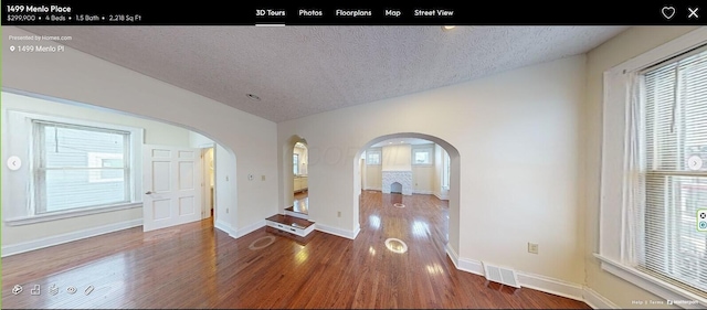 interior space featuring a textured ceiling and hardwood / wood-style flooring