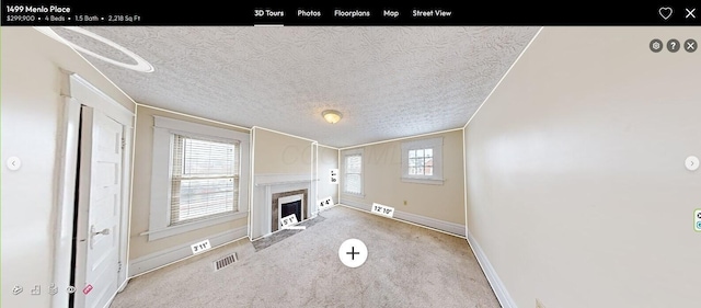 unfurnished living room featuring a textured ceiling and light carpet