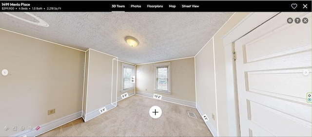 unfurnished bedroom with a textured ceiling, light carpet, and ornamental molding