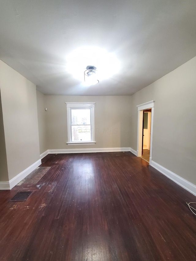 spare room featuring dark hardwood / wood-style flooring