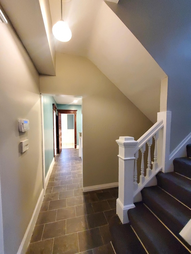 stairs featuring vaulted ceiling