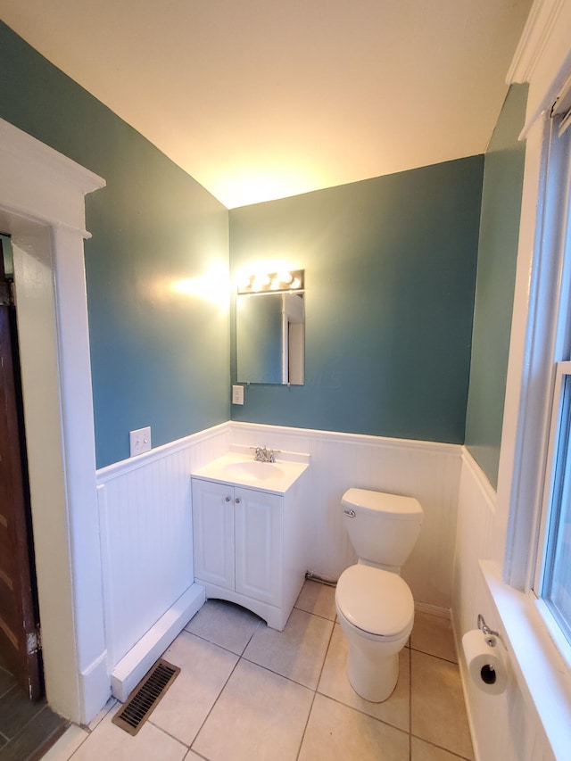 bathroom with tile patterned flooring, vanity, and toilet