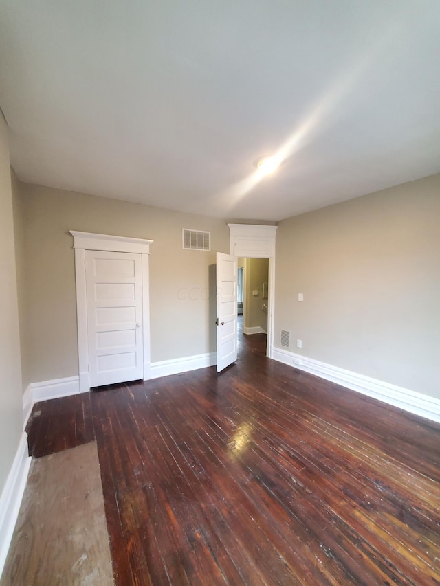 spare room with dark wood-type flooring