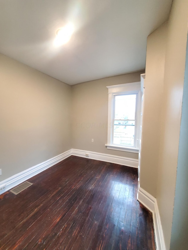 spare room with dark hardwood / wood-style floors