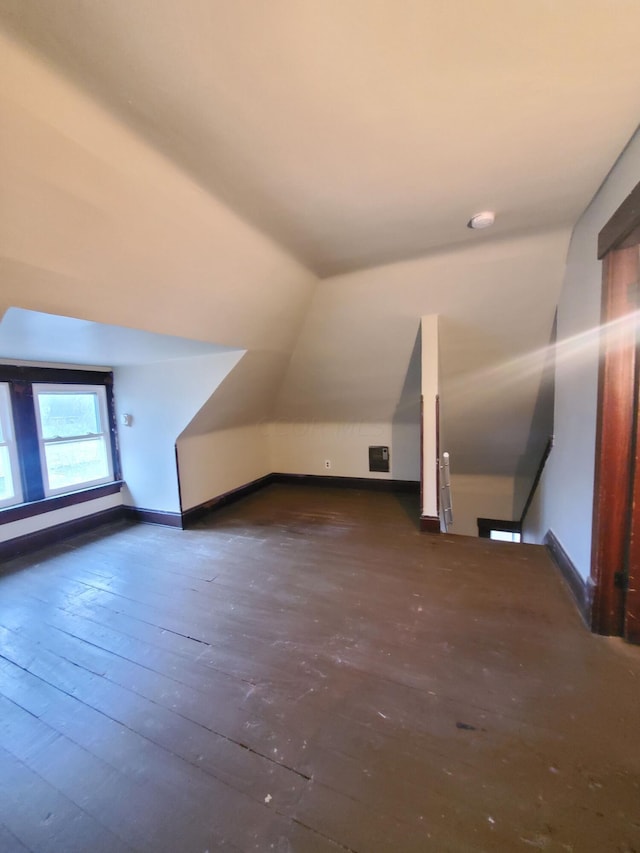 bonus room with lofted ceiling and dark hardwood / wood-style floors