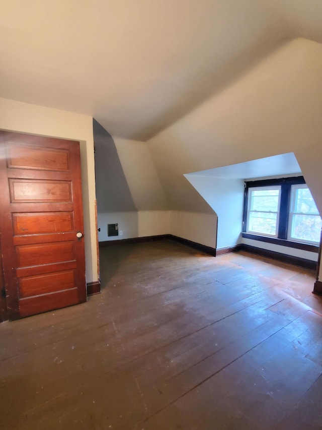 additional living space featuring dark hardwood / wood-style flooring and lofted ceiling