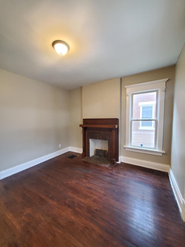 unfurnished living room featuring dark wood-type flooring