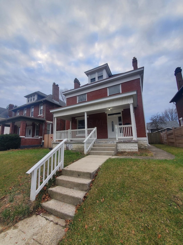 view of front facade with covered porch and a front yard