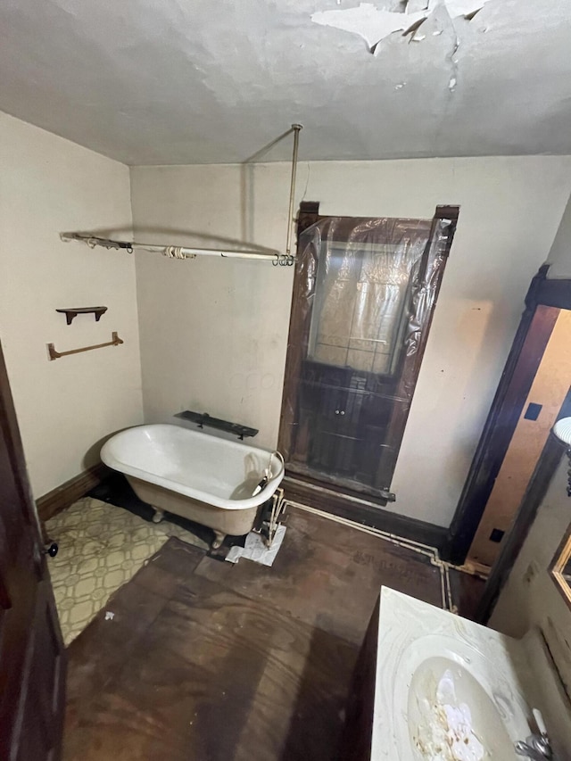 bathroom featuring vanity and a tub to relax in