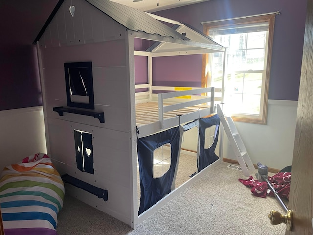 bedroom featuring carpet flooring and multiple windows