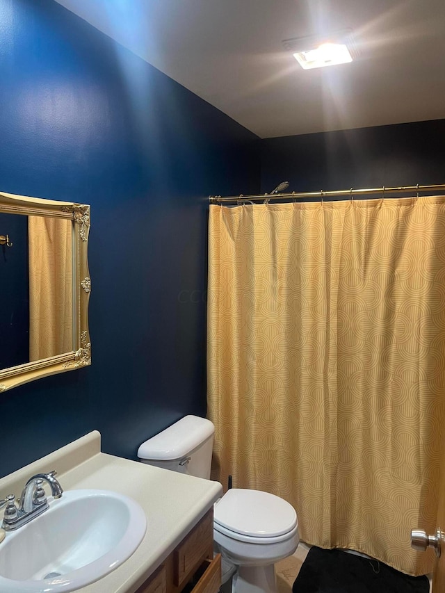 bathroom featuring tile patterned floors, vanity, and toilet