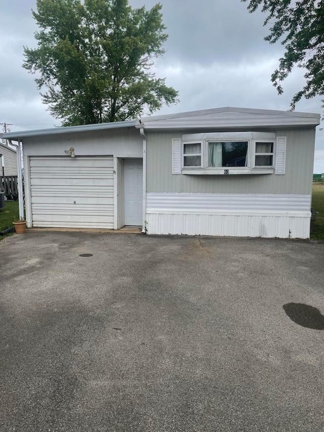 view of front facade with a garage and central AC unit