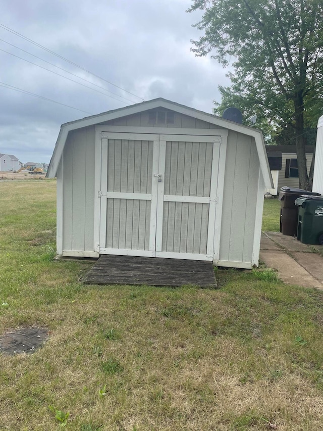 view of outbuilding with a yard