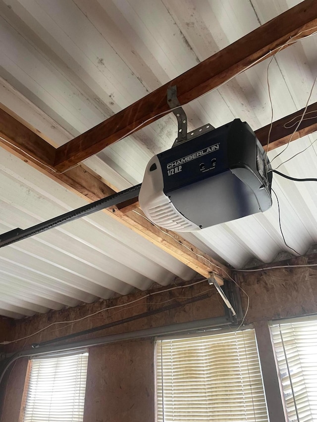 details featuring beamed ceiling and a garage door opener