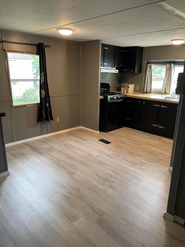 kitchen featuring black gas stove and light wood-type flooring