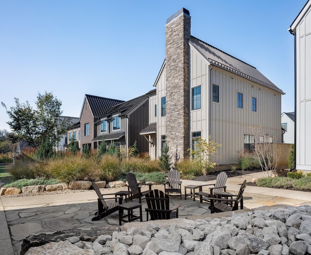 back of house featuring a fire pit and a patio area