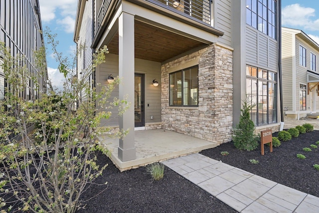 entrance to property featuring stone siding