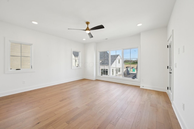 unfurnished room featuring light wood finished floors, baseboards, and ceiling fan