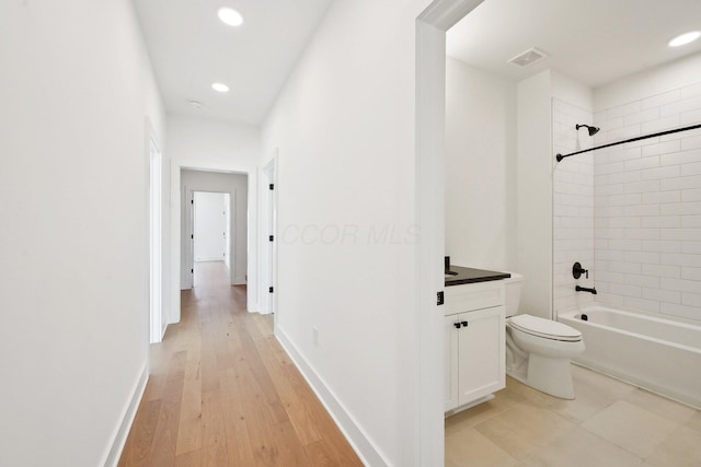 full bathroom with tub / shower combination, toilet, visible vents, and recessed lighting