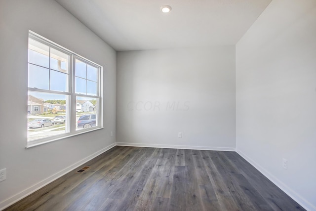 empty room featuring dark hardwood / wood-style flooring