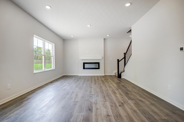 unfurnished living room featuring wood-type flooring