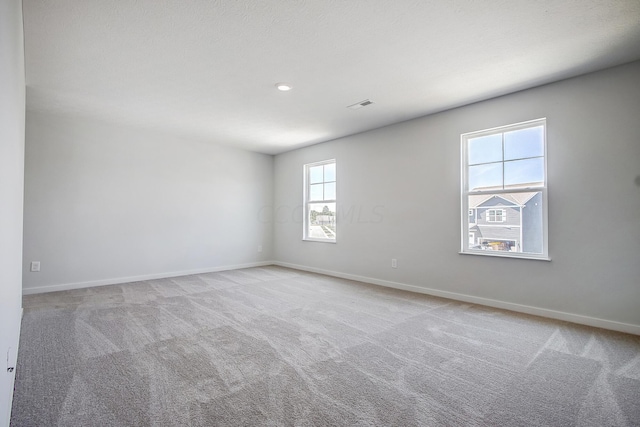 carpeted empty room featuring a healthy amount of sunlight